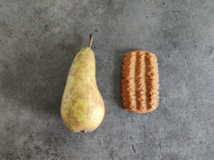 Cookie vs Pear: Cookie has more calories than pear but is smaller and lighter