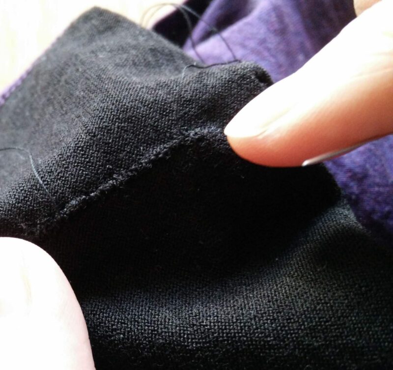 With the inside out once again, prepare to finish the process by securing the thread to the fabric.