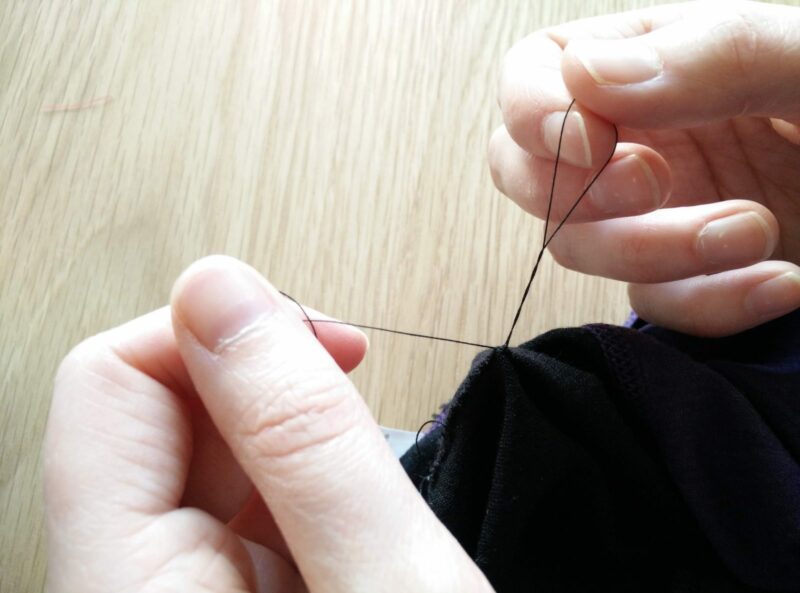 After having the needle one last time, you only pull it so far that you have enough thread on each side to comfortably tie a knot.