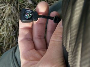 CimAlp Laos Hiking Pants: A small working compass on hand pocket's pull loop