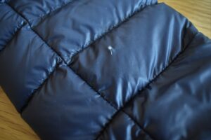 How to Repair a Down Jacket - a clear patch will let the insulation be seen through