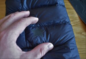 How to Repair a Down Jacket - hole covered by patch