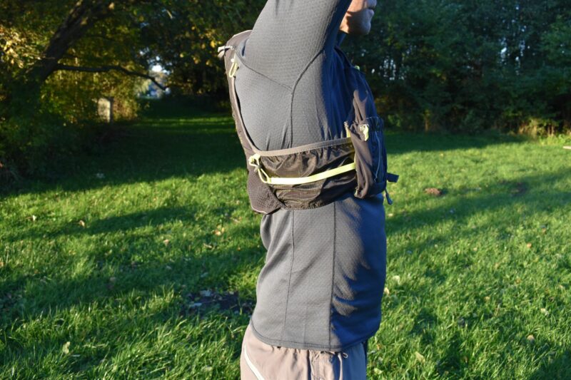 You adjust a hydration vest by making the sides of the vest shorter or longer