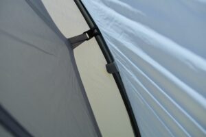 Sea to Summit Telos TR3 Tent - the canopy is attached to the poles with hooks while the fly is attached with velcro tabs
