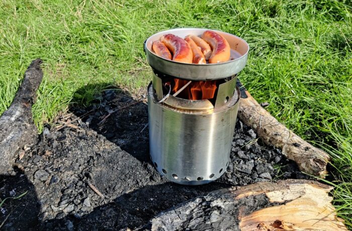 You add wood through the small hole in cooking ring when you have a pan on it